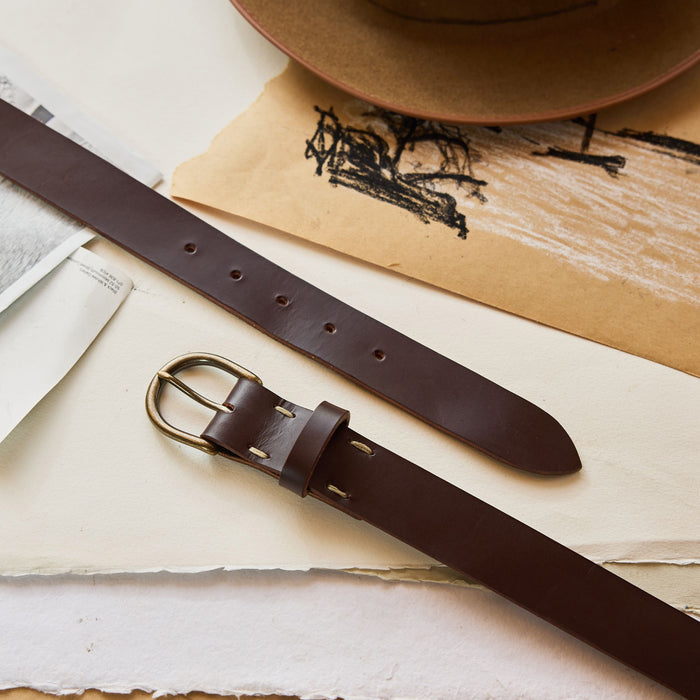editorial image of The Foundation Belt in Dark Brown on sheets of paper