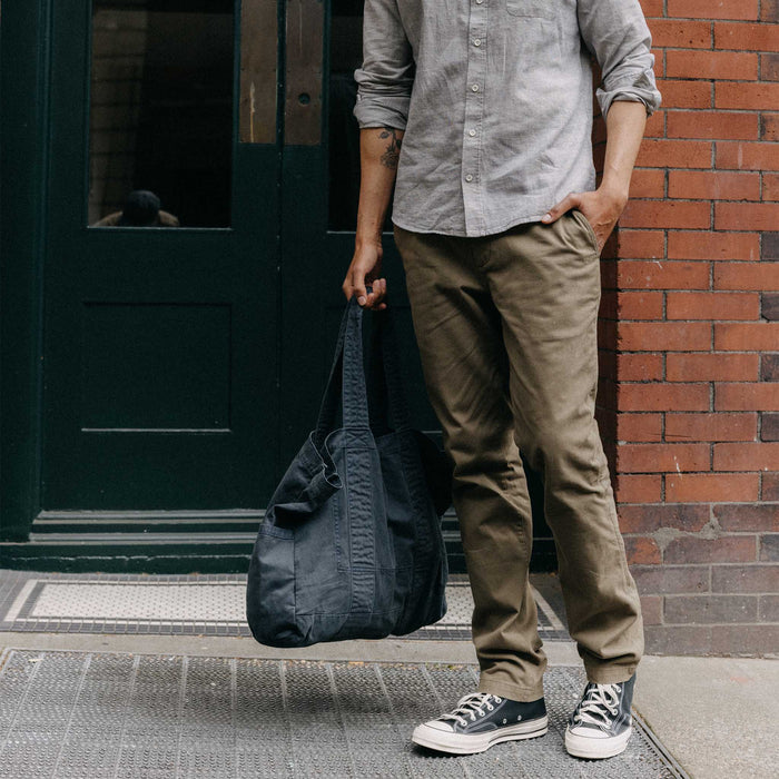fit model walking holding The Foundation Tote in Organic Navy