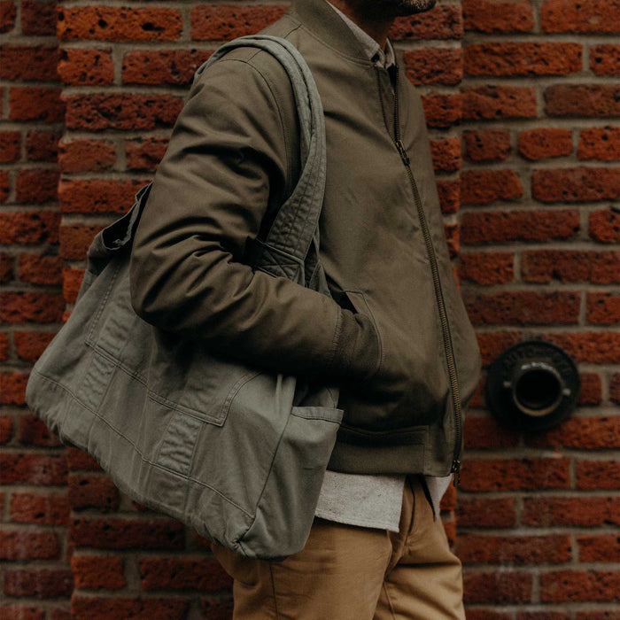 fit model holding The Foundation Tote in Organic Smoked Olive