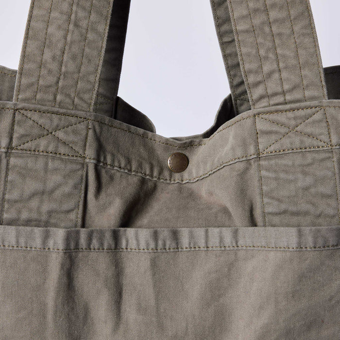 editorial image of the button snap on The Foundation Tote in Organic Smoked Olive