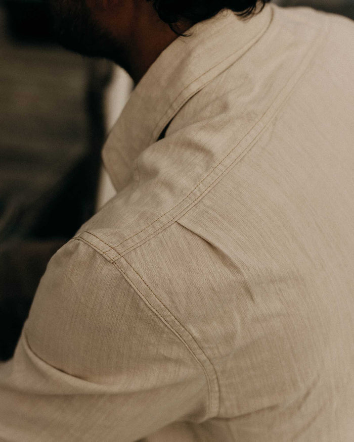 fit model showing off the back of The Foundry Shirt in Natural Chambray