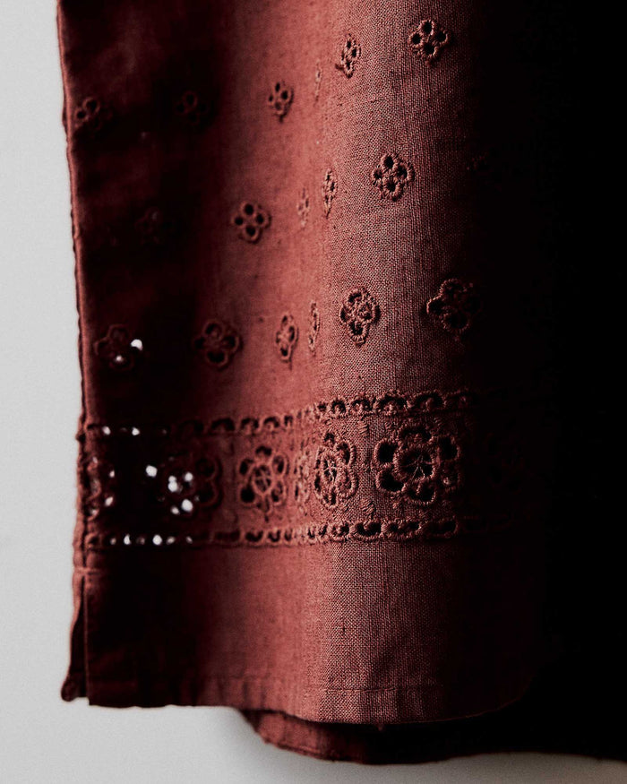 editorial image of the eyelet on The Hawthorne Shirt in Red Wine Border Eyelet