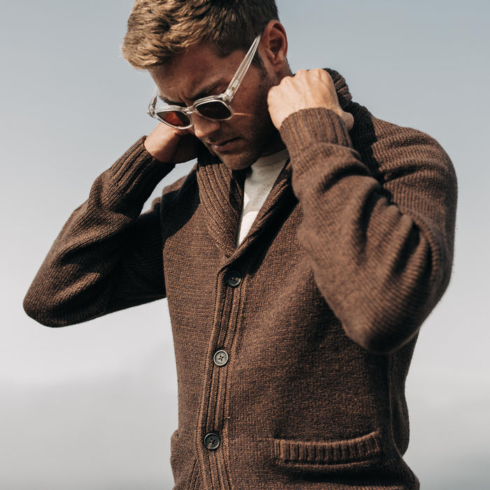 fit model adjusting collar on The Headland Shawl Cardigan in Marled Chocolate