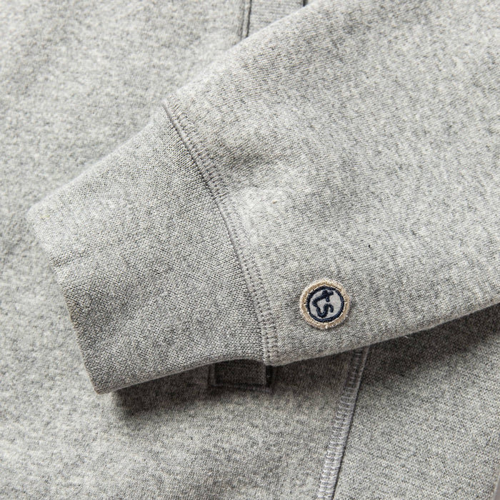 material shot of The Heavy Bag Bomber in Heather Grey Fleece's cuff with TS logo embroidery