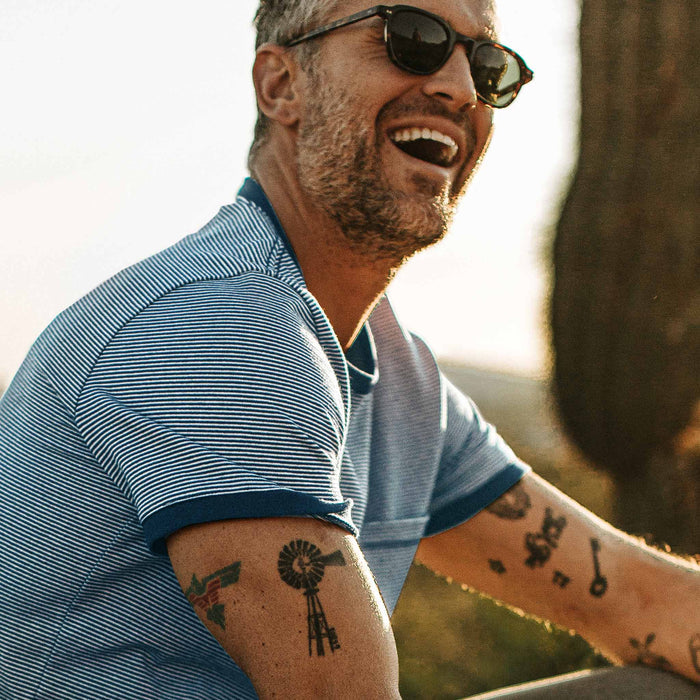 our fit model laughing and wearing The Heavy Bag Ringer in Royal Blue Stripe out in the desert at sunset