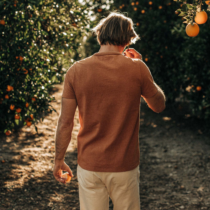 fit model showing the back of The Heavy Bag Tee in Apricot
