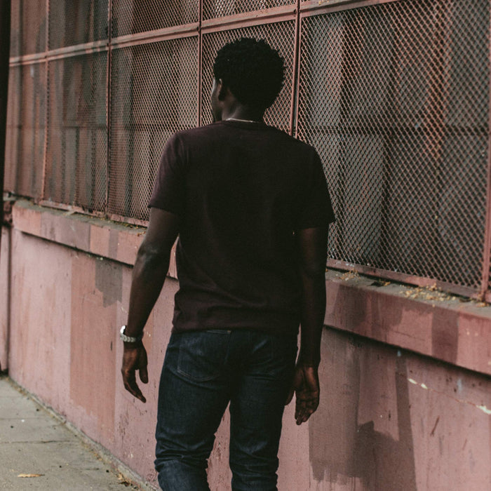 The fit model wearing the heavy bag tee in burgundy.