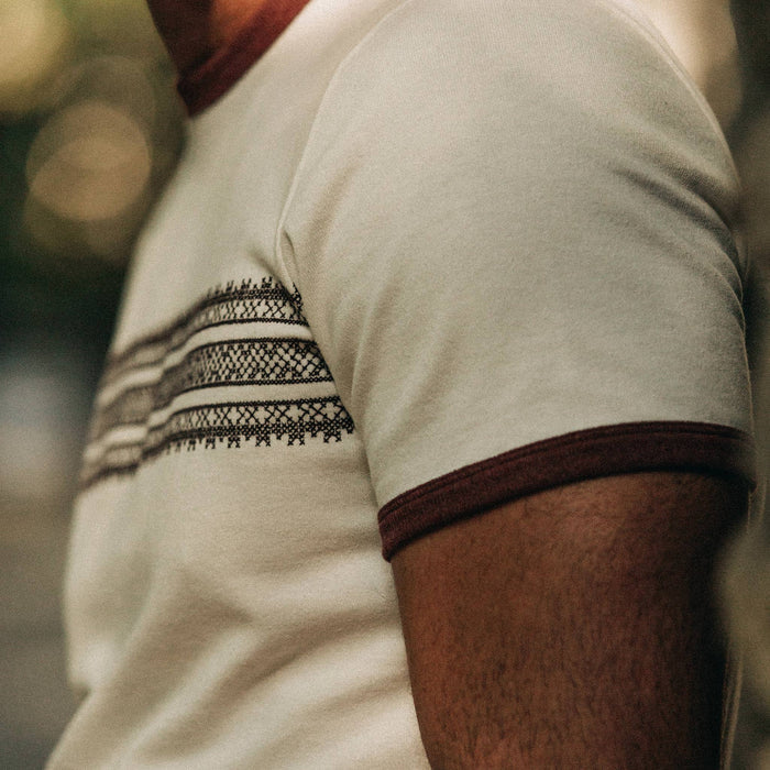 fit model wearing The Heavy Bag Tee in Canyon Embroidered Stripe, sleeve detail