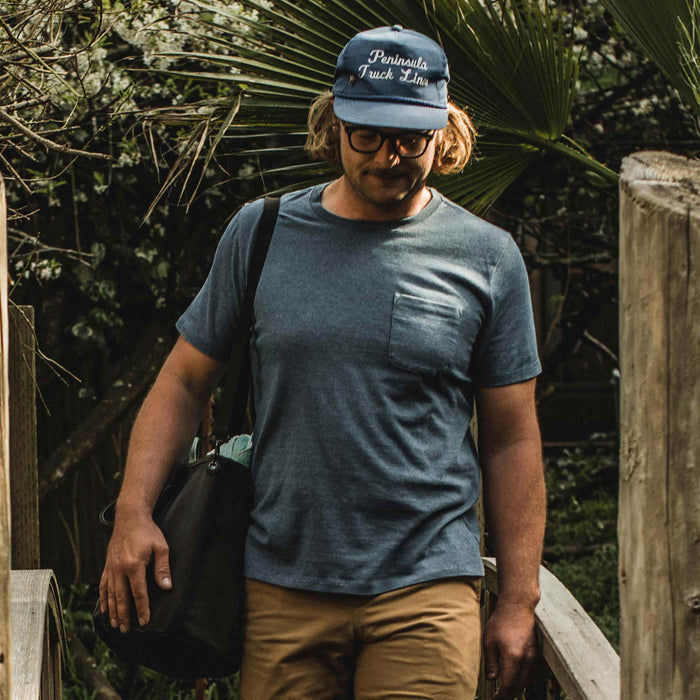 The fit model wearing The Heavy Bag Tee in Dusty Blue from Taylor Stitch.