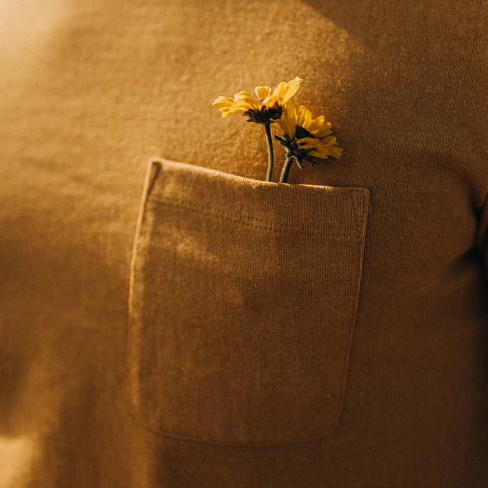 fit model showing the chest pocket on The Heavy Bag Tee in Gold