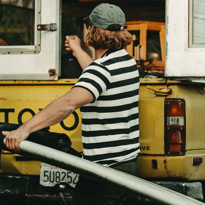 Our fit model wearing The Heavy Bag Tee in Natural & Navy Rugby Stripe by Taylor Stitch.