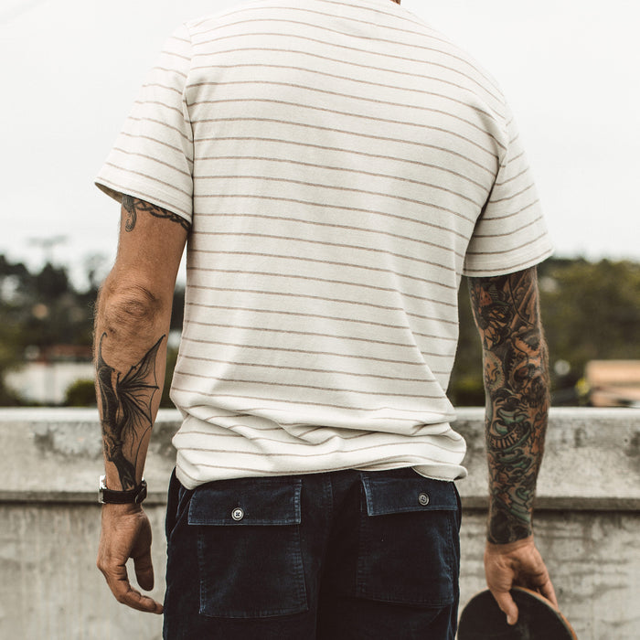 Our fit model skateboarding in The Heavy Bag Tee in Natural Stripe