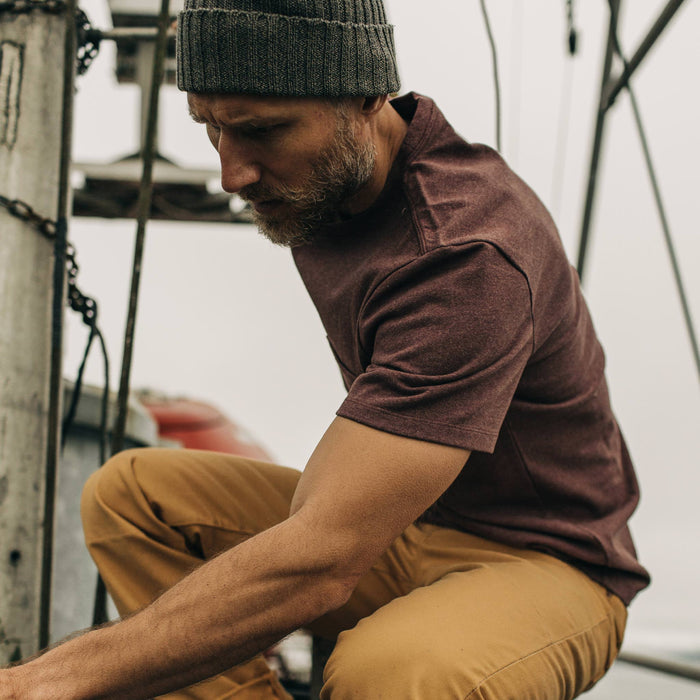 fit model wearing The Heavy Bag Tee in Russet while sitting on a boat