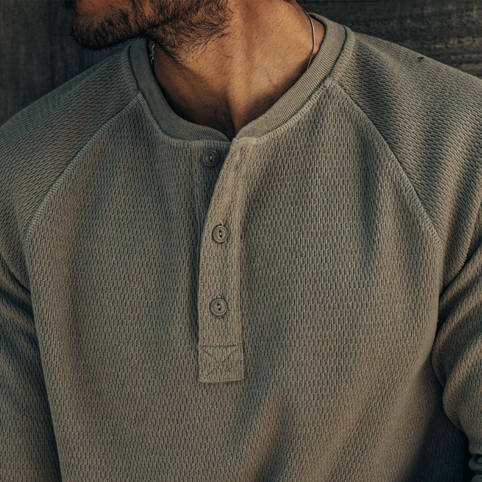 fit model showing off buttons on The Heavy Bag Waffle Henley in Army