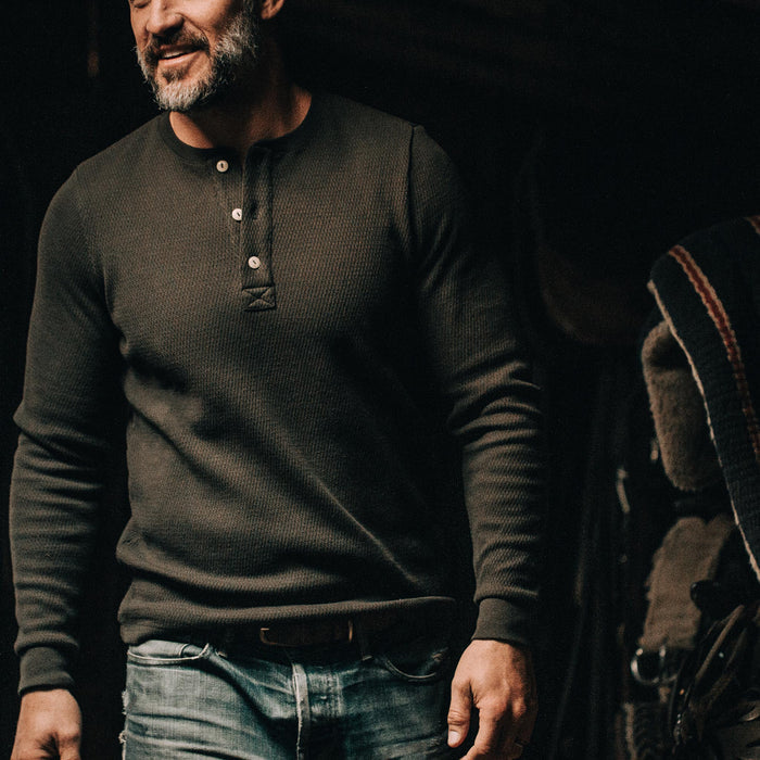 our fit model wearing The Heavy Bag Waffle Henley in Olive—looking left