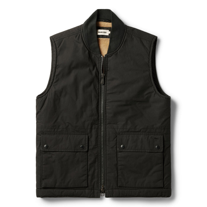 flatlay of The Ignition Vest in Coal Dry Wax