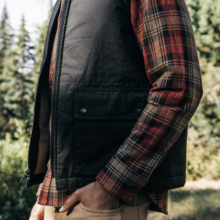 fit model walking in The Ignition Vest in Coal Dry Wax