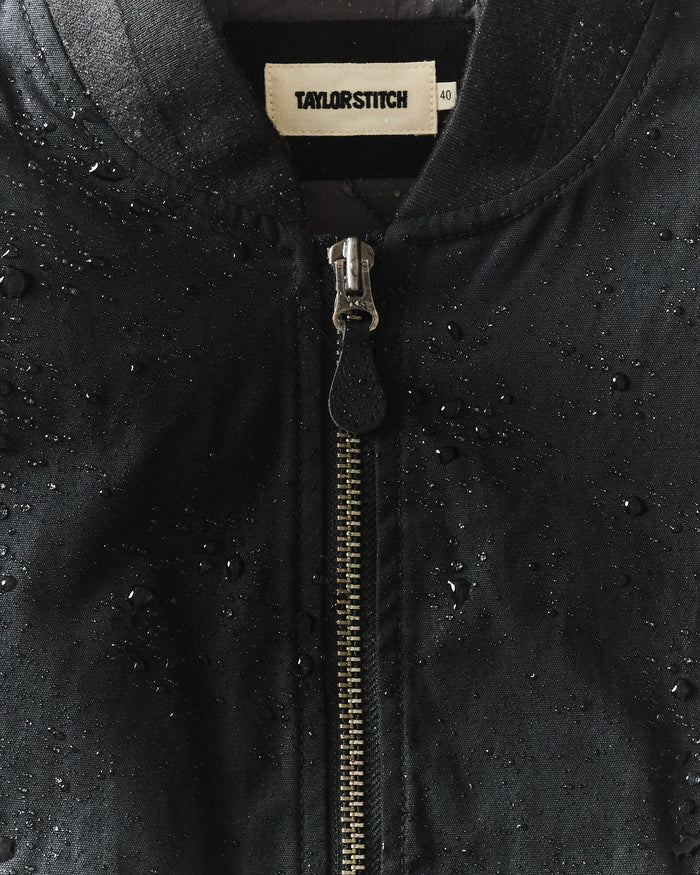 fit model showing the back of The Insulated Bomber Jacket in Coal Dry Wax