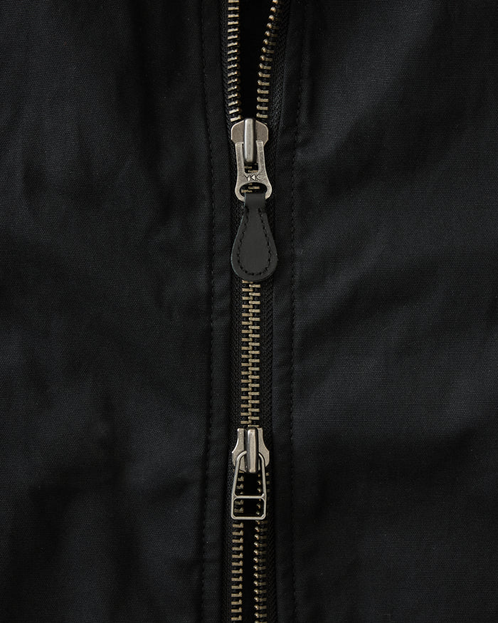 fit model standing in The Insulated Bomber Jacket in Coal Dry Wax