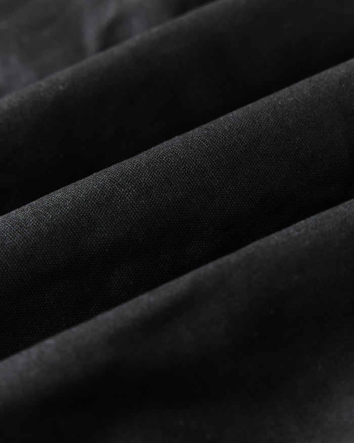 material shot of the ribbed neck opening on The Insulated Bomber Jacket in Coal Dry Wax