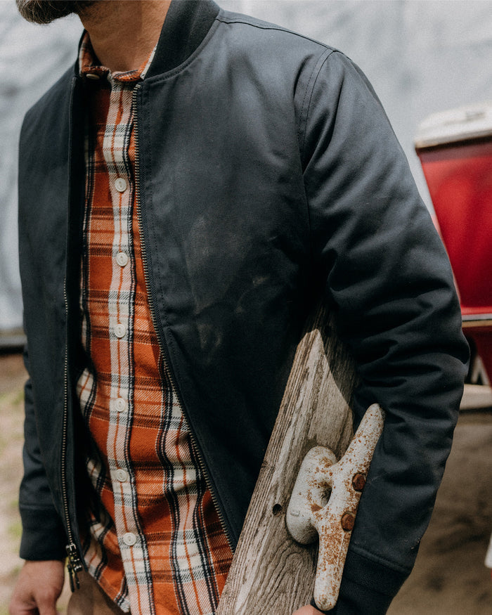 fit model posing in The Insulated Bomber Jacket in Dark Navy Dry Wax