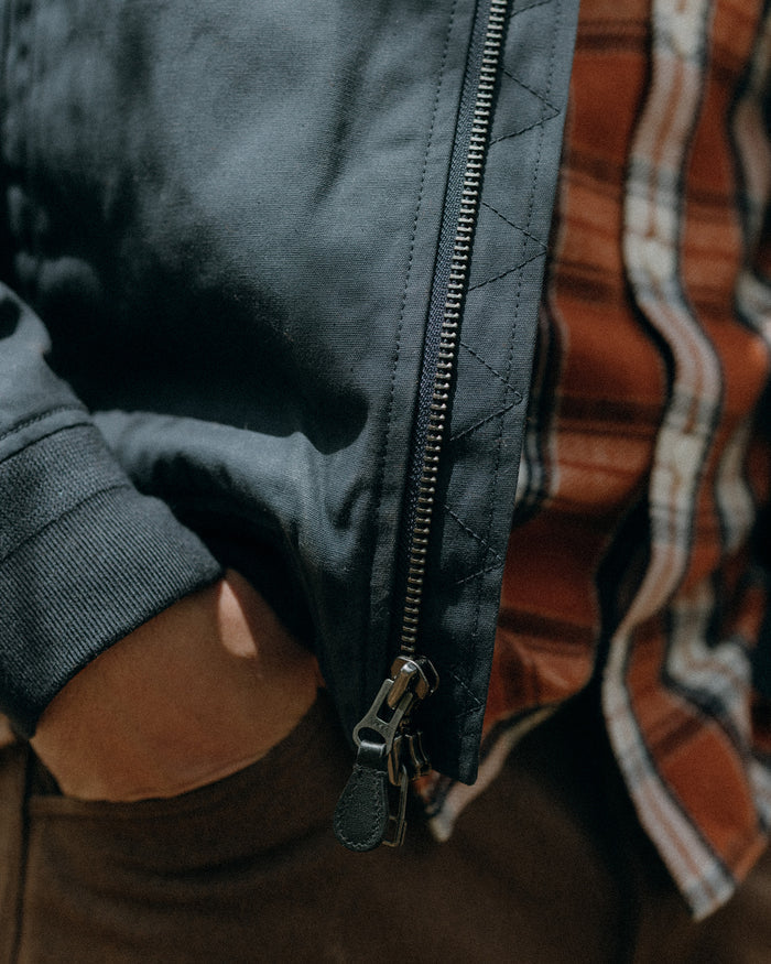 fit model showing off the zipper on The Insulated Bomber Jacket in Dark Navy Dry Wax