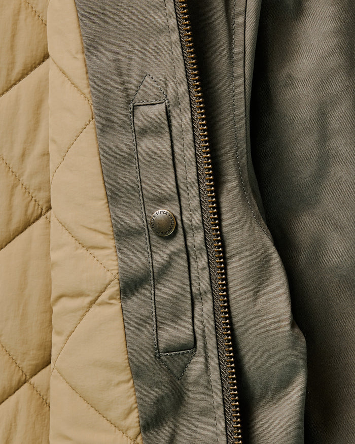 flatlay of The Insulated Bomber Jacket in Fatigue Olive Dry Wax, shown from the back