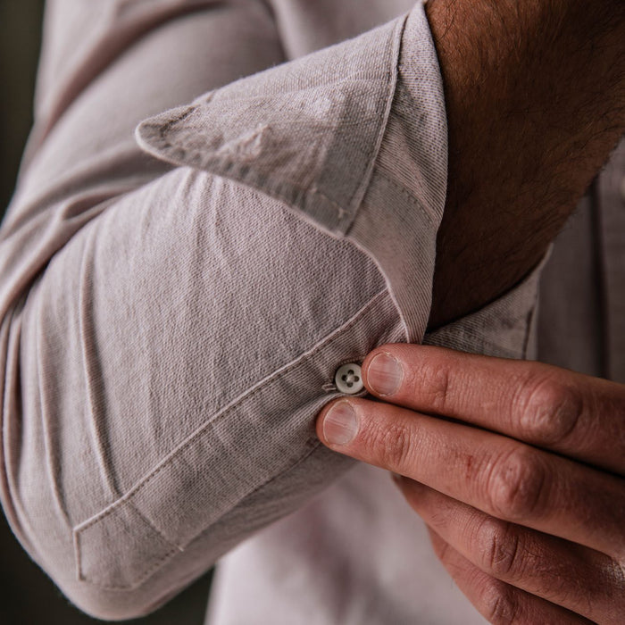 fit model buttoning the cuffs on The Jack in Antique Terracotta Micro Seersucker