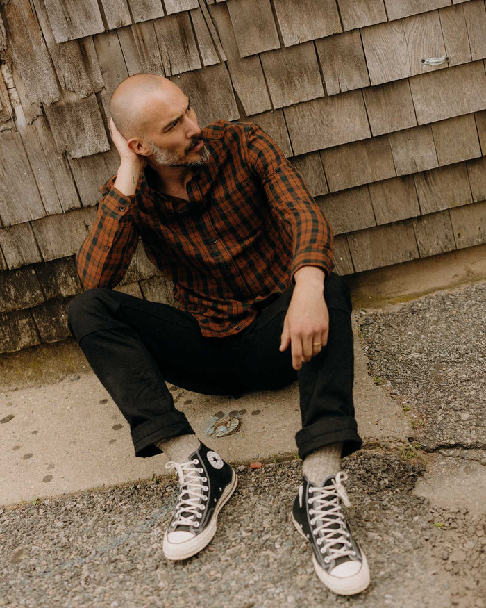 fit model sitting wearing The Jack in Autumn Pine Plaid Flannel