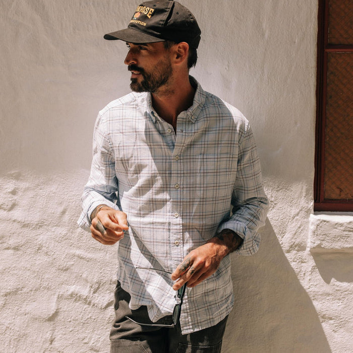 fit model leaning against the wall wearing The Jack in Blue Fade Plaid