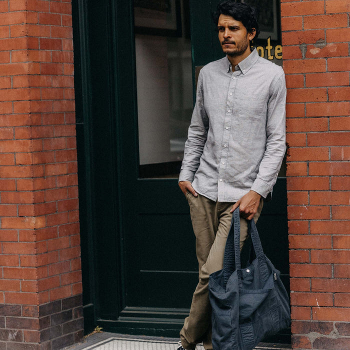 fit model leaning against the wall wearing The Jack in Blue Sky Slub Cotton Linen