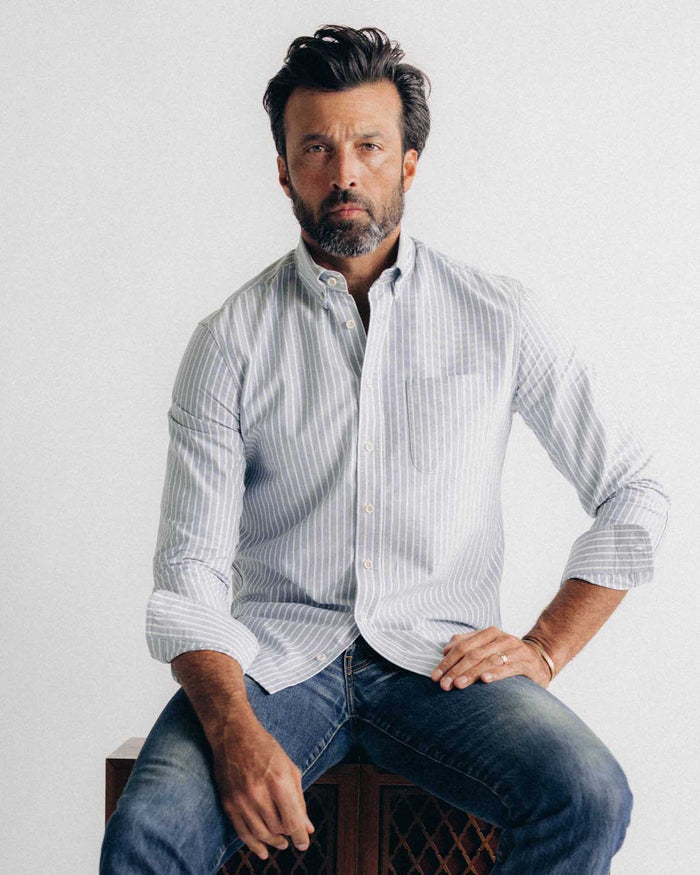 fit model sitting wearing The Jack in Blue Sky Stripe Oxford