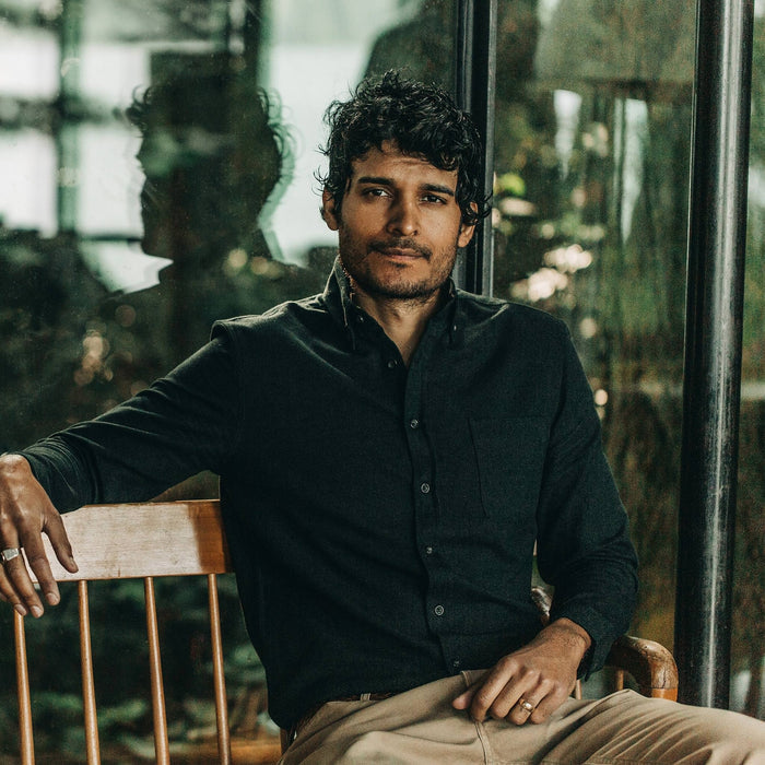 our fit model wearing The Jack in Brushed Forest Oxford—sitting on chair