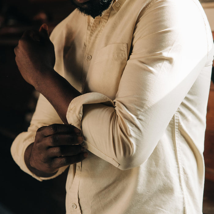fit model rolling up the sleeves of The Jack in Butter Oxford