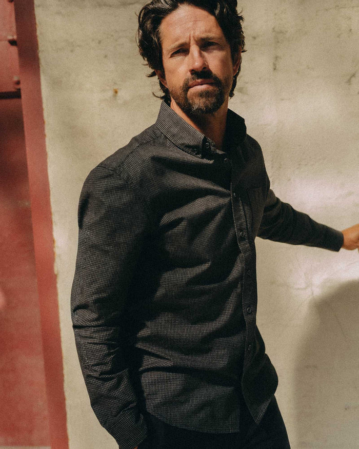 fit model adjusting the cuffs on The Jack in Coal Jaspe Check Oxford