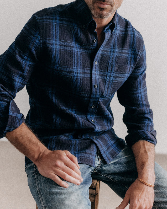 fit model sitting wearing The Jack in Deep Indigo Plaid Waffle