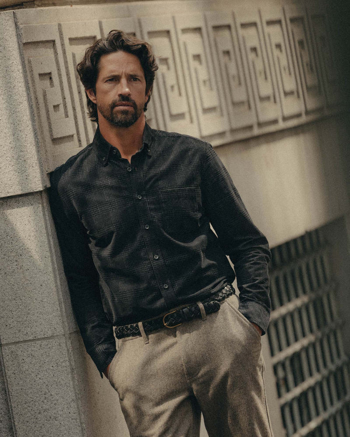 fit model leaning against the wall wearing The Jack in Heather Coal Check Pincord