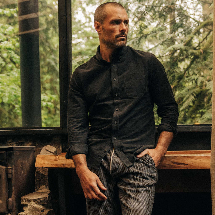 fit model leaning against a chair wearing The Jack in Heather Coal Pincord