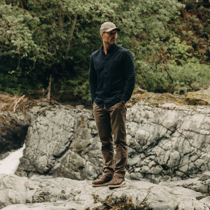 fit model standing on a rock wearing The Jack in Heather Marine Pincord