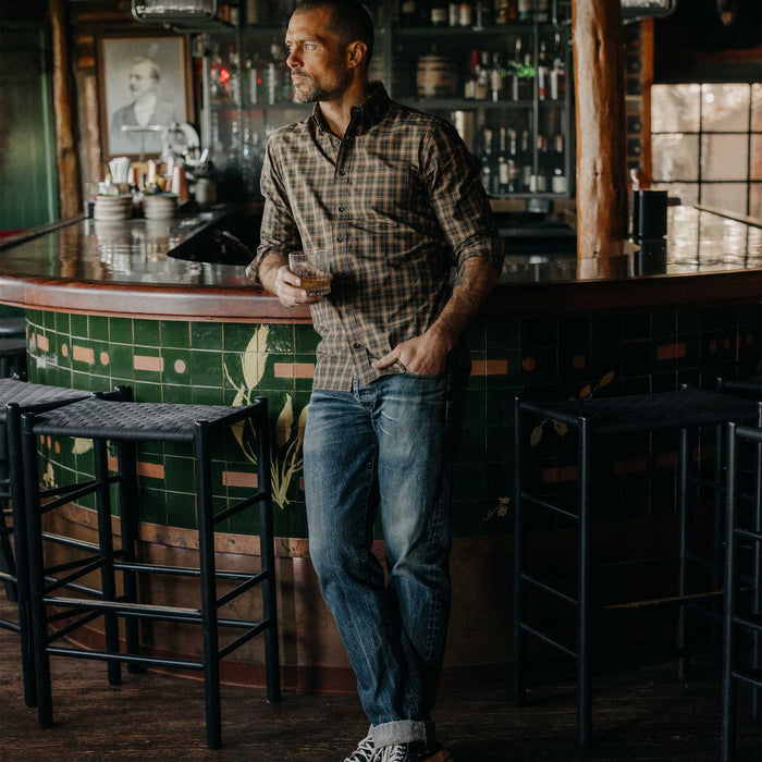 fit model leaning against a bar wearing The Jack in Mulch Plaid
