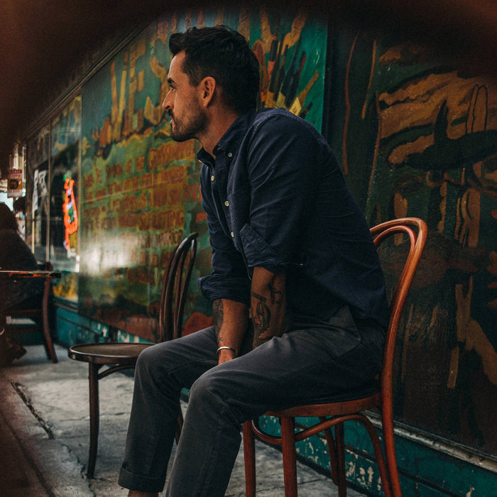 fit model wearing The Jack in Navy Oxford, looking left, sitting
