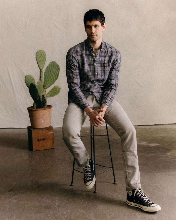 fit model sitting wearing The Jack in Navy Plaid Linen