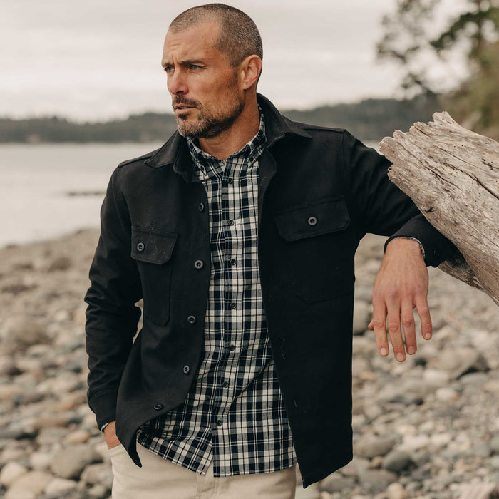 fit model leaning against a tree wearing The Jack in Rinsed Indigo Plaid