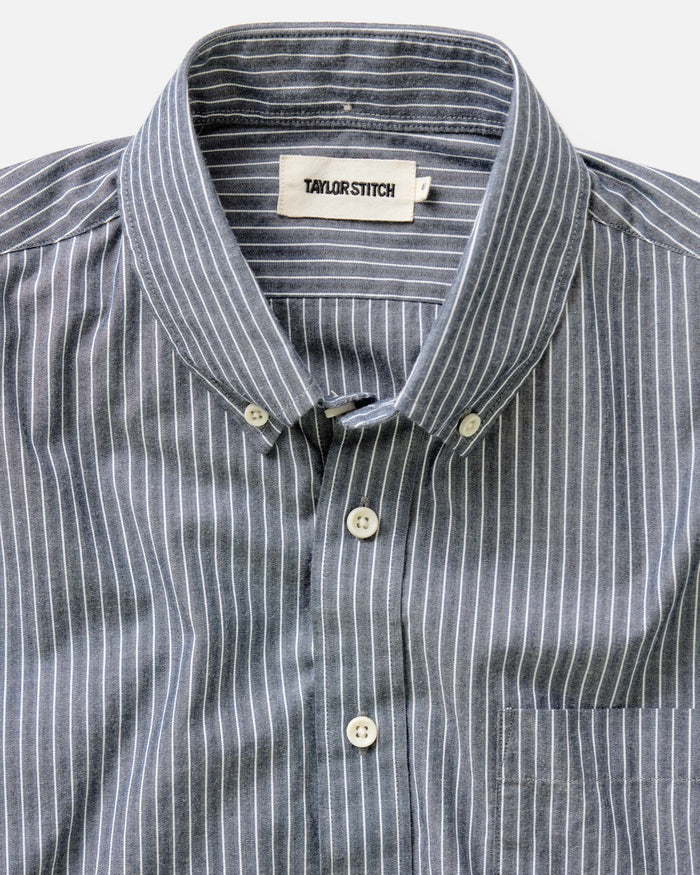 fit model sitting wearing The Jack in Rinsed Indigo Stripe