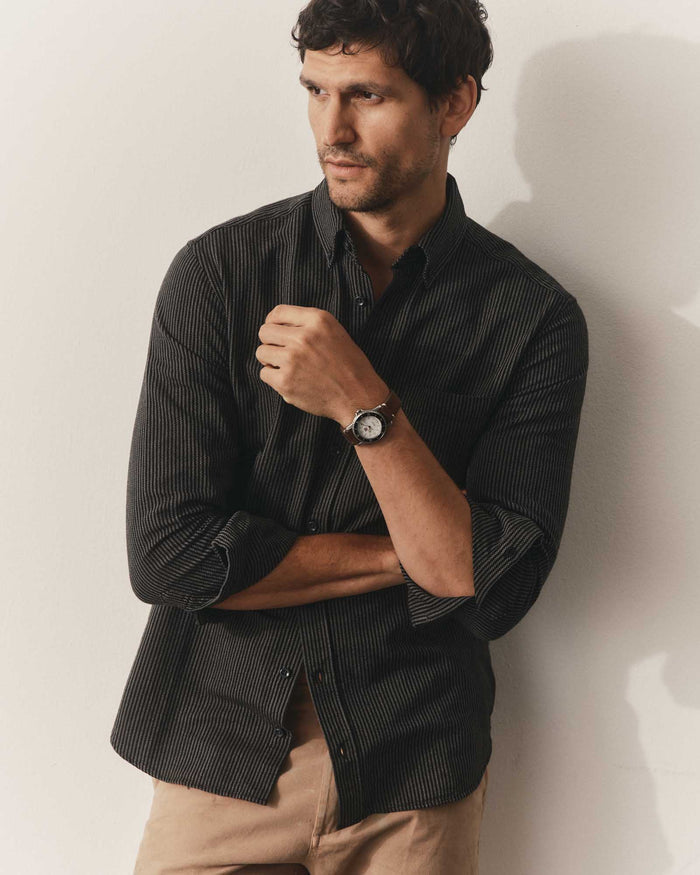 fit model leaning against the wall wearing The Jack in Roped Black Indigo