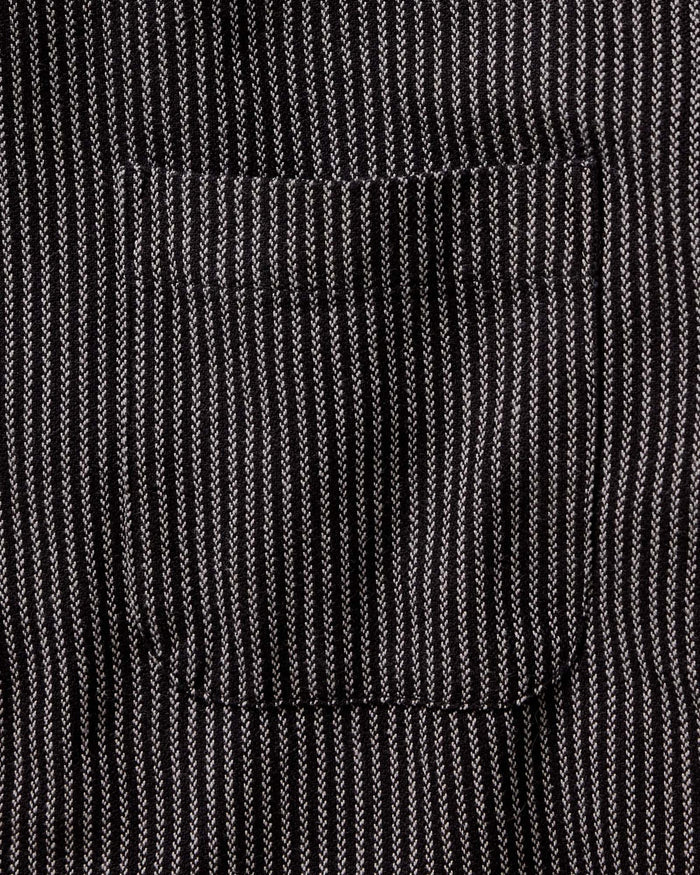 fit model adjusting the cuffs on The Jack in Roped Black Indigo