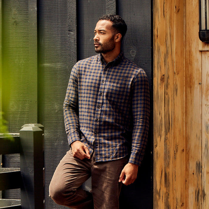fit model leaning against a wall in The Jack in Terrace Plaid
