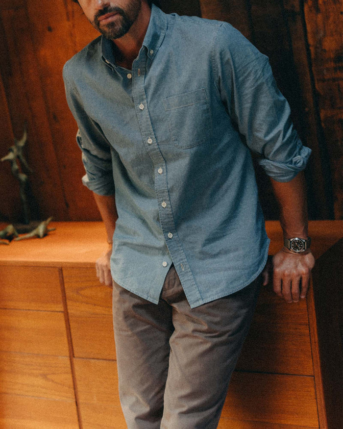 fit model leaning against a dresser wearing The Jack in Washed Indigo Chambray