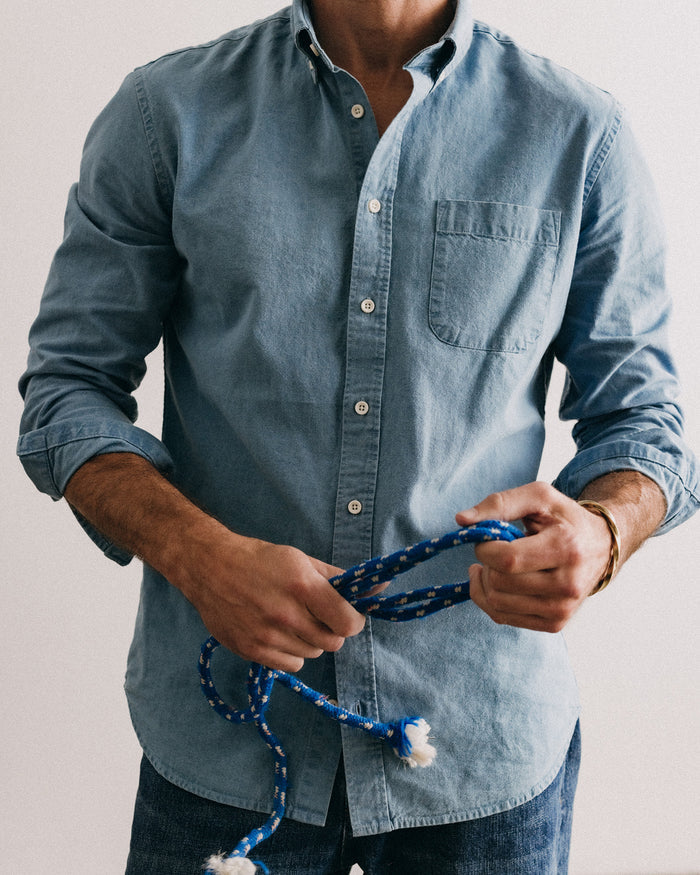 fit model leaning against the wall wearing The Jack in Washed Indigo Oxford