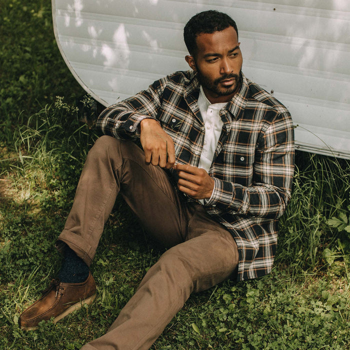 fit model sitting in The Ledge Shirt in Admiral Plaid
